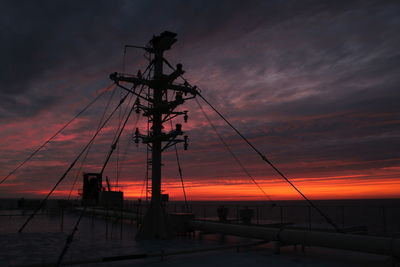 Ship's main mast under a crimson sky