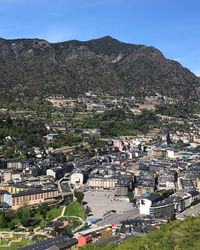 High angle view of townscape and mountains against sky