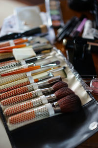 Variety of make-up brushes on table