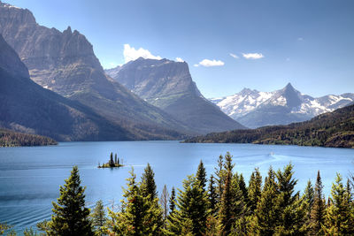 Scenic view of st mary lake against rocky mountains during winter