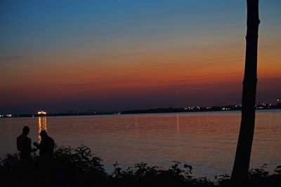 Silhouette of people at sunset