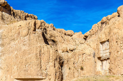 Low angle view of rock formations against sky