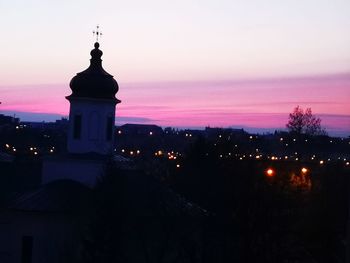 Silhouette of buildings against sky at dusk