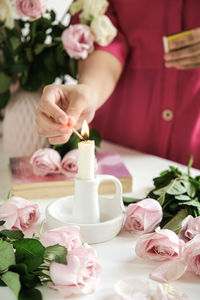 Midsection of woman with christmas decorations on table