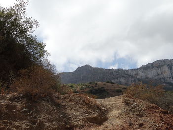 Scenic view of mountains against cloudy sky