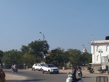 Cars on road against clear sky