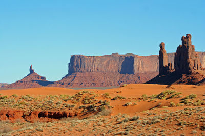 View of rock formations on landscape against blue sky