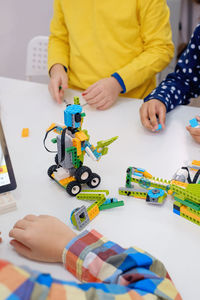 Students in school computer coding class building and learning to program robot vehicle. multi