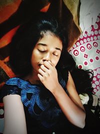 High angle view of girl sleeping on bed