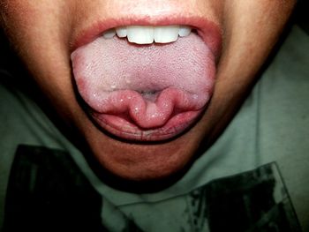 Close-up of woman sticking out tongue