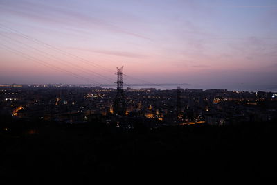 High angle view of illuminated buildings against sky at sunset