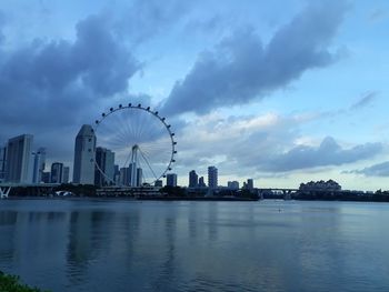 River in city against cloudy sky