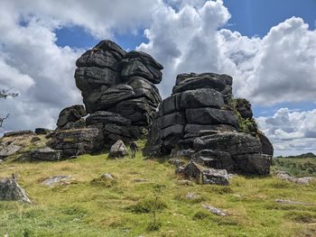 Low angle view of rocks on field against sky