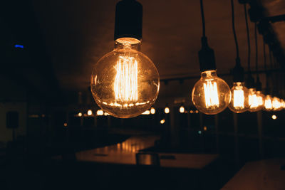 Illuminated light bulbs hanging from ceiling