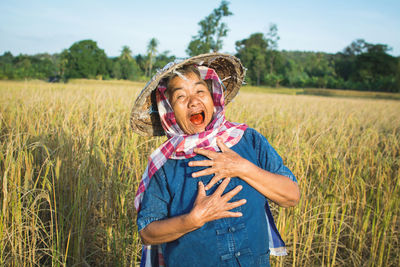 Senior farmer standing on field