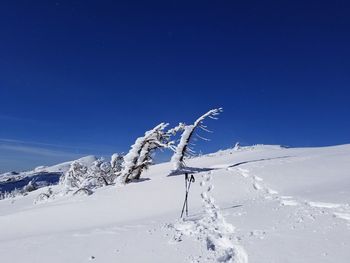 Snow covered mountain against blue sky