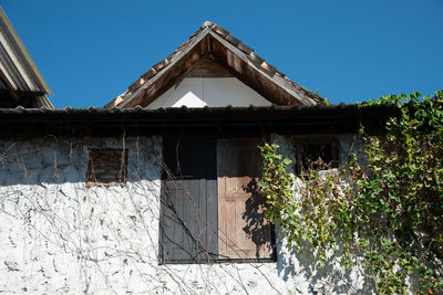 Low angle view of old building against clear blue sky