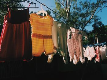 Low angle view of clothesline against trees