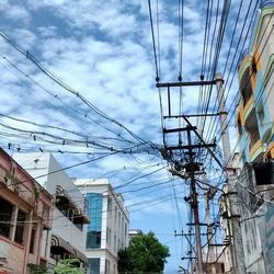 Low angle view of electricity pylon against sky