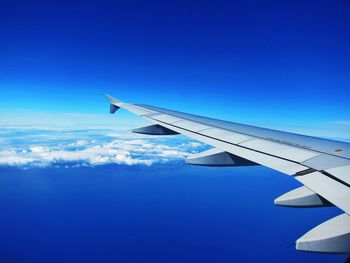 Airplane wing against blue sky