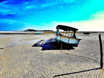 Low angle view of deck chairs against blue sky