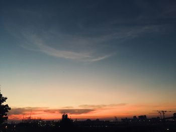 Silhouette buildings against sky during sunset