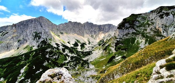 Panoramic view of green mountains against sky