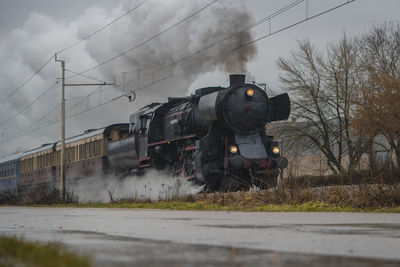 Train on railroad track against sky