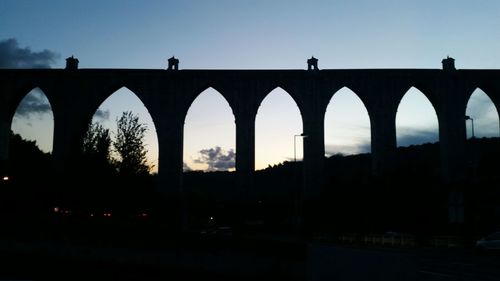 Silhouette of bridge against clear sky