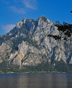 Scenic view of sea and mountains against sky