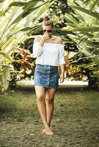 Young woman standing on grass