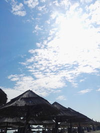 Houses against cloudy sky