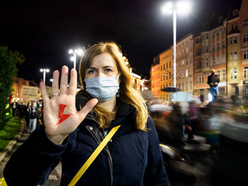 Woman has drawn a sign lightning on hand. women protest against tightening of abortion law. poland.