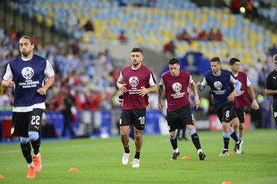 Group of people playing soccer on field