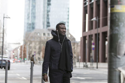 Man standing on street in city