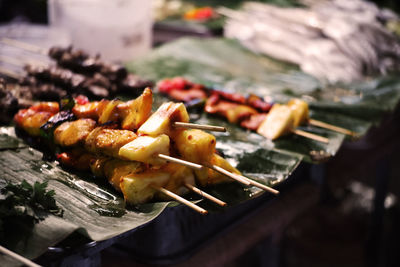 High angle view of meat on skewers in plate