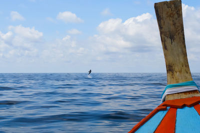 Scenic view of wooden post in sea against sky