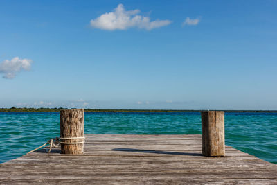 Pier over sea against blue sky