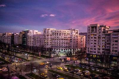 High angle view of illuminated cityscape against sky at night