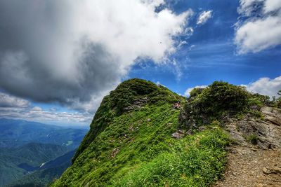 Scenic view of mountain against cloudy sky