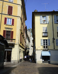 Footpath amidst buildings in city