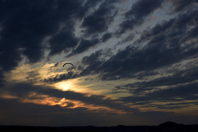 Low angle view of silhouette person against sky during sunset