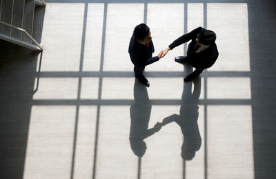 High angle view of people standing on floor in city
