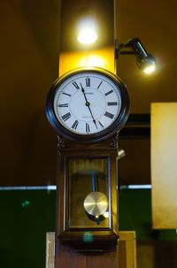 Low angle view of illuminated clock
