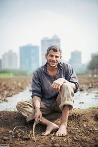 Portrait of smiling young man on field