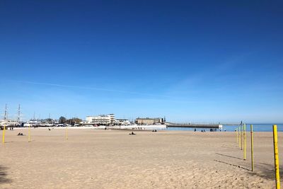 Scenic view of beach against clear blue sky