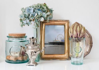 Flowers in glass jar on table