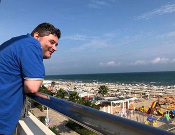 Man standing by sea against sky