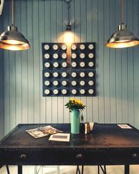 Illuminated light bulb on table