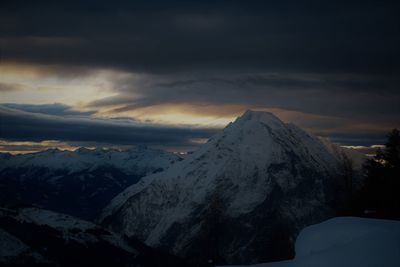 Scenic view of snowcapped mountains against sky during sunset